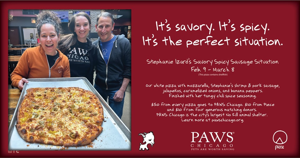Stephanie Izzard posing beside her savory and spicy shrimp sausage and jalapeno pizza that benefits Paws.